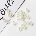 Detailed close-up of square AB crystal beads with multifaceted aurora finish for DIY jewelry - Off-white