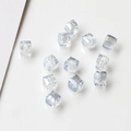 Macro detail of faceted light blue crystal cube beads for DIY handmade jewelry making - Transparent White