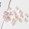 Macro shot of shimmering champagne AB crystal cube beads for DIY jewelry making - Light Pink