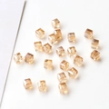 Macro shot of sparkling champagne gold square crystal beads with faceted finish and holes - 12# Light Brown