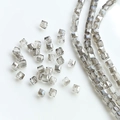 Macro shot of smoky grey square cut crystal beads with center hole for DIY jewelry making - Grey