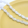 Macro shot of oval millefiori glass beads with white spiral floral patterns for jewelry - Approx. 32 Pcs/Strand (8x13mm) / White