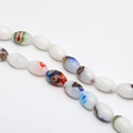 Macro detail of oval Millefiori glass beads with colorful floral patterns for DIY jewelry - Approx. 32 Pcs/Strand (8x13mm) / Solid White Multi-color