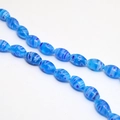 Close-up of blue floral millefiori glass beads with intricate swirl patterns for DIY jewelry - Approx. 32 Pcs/Strand (8x13mm) / Sky Blue