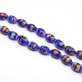 Macro detail of blue millefiori glass beads with colorful floral and stripe patterns - Approx. 32 Pcs/Strand (8x13mm) / Sapphire Blue