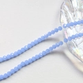 Macro shot of 4mm faceted light blue crystal rondelle beads on a seashell tray - Aqua Blue (3#)