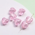 Close-up of pink glass heart beads with silver glitter for DIY jewelry making - Light Pink