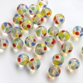 Macro shot of colorful dotted translucent glass beads for DIY jewelry making and crafts - Multicolor Polka Dot Style