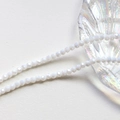 Macro shot of 4mm faceted translucent white crystal glass beads on a seashell dish - White (11#)