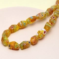 Close-up of yellow Millefiori faceted glass beads for DIY jewelry making - Multifaceted (Yellow) (1 Strand)