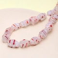 Macro detail of faceted white floral glass beads with orange stripes for DIY jewelry - Faceted Cut Shape (Red & White) (1 Strand)
