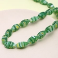 Detail of green floral lampwork glass beads with faceted texture for jewelry making - Teardrop Shape (Light Green) (1 Strand)