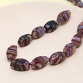 Macro shot of faceted purple floral glass beads with colorful stripes for DIY jewelry making - Teardrop Shape (Coffee) (1 Strand)