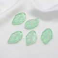 Detailed macro of five translucent light green Czech glass leaf charms for DIY hair ornaments - Light Green
