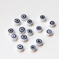Macro shot of evil eye beads with smooth finish and central drill holes for DIY jewelry - Black And White Evil Eye (D1588) / Black & White