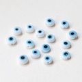 Macro shot of flat glass evil eye beads for DIY handmade jewelry crafting and beading - Blue & White