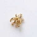 Macro view of gold-plated octopus pendant with tiny crown and trident details - Crowned Octopus Style (5#)