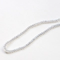 Macro detail of faceted light blue crystal beads for handmade jewelry DIY necklaces - 1 Piece / Off-White