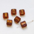 Macro view of translucent amber glass square beads with gold foil foil insert for DIY jewelry - Red Brown