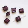 Macro detail of translucent purple square glass beads with golden metal pin for DIY jewelry - Deep Rose Red