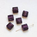 Macro shot of translucent purple square glass beads with inner silver foil for DIY crafts - Deep purple