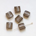 Macro detail of translucent square glass beads with silver foil foil and hole structure - Gray