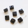 Close-up of handmade translucent black square glass beads with irregular glossy surface - Black