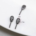 Macro detail of 4x6.7mm black nickel plated teardrop rabbit ear charm with cubic zirconia - Gun Black Zircon Rabbit Ears
