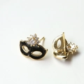 Close-up of gold-plated masquerade mask earrings with black enamel and zircons - Black Mask with Gold Base