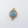 Macro detail of gold oval moon pendant with opal center and zircon micro-pave setting - Water Blue Oval (D1685)