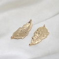 Macro shot of gold-plated leaf connectors with realistic veins for DIY jewelry making - Double Loop Leaf Pendant