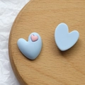 Nahaufnahme herzförmiger Harzanhänger in Pastellblau und Rosa für DIY-Accessoires - Blau