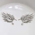 Detailed view of silver wing-shaped earring components with fine feather textures - White Gold