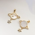 Detailed front and back views of a gold-plated Saturn planet charm with mother-of-pearl - Planet Shell Pendant