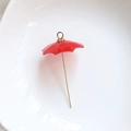 Macro detail of a bright red resin umbrella charm with gold metal handle and top loop - Red Umbrella (Style 5)