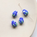 Detailed view of deep blue drop-shaped glass beads with green and white dot patterns - 1 Piece / Royal Blue (4#)