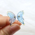 Macro shot of gradient blue and purple resin butterfly wing earrings with gold bead detail - Gradient Blue Butterfly