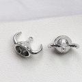 Macro shot of silver horned viking helmet pendants for DIY jewelry and necklaces - Bull King Hat / White Gold
