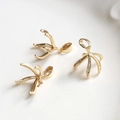 Macro detail of gold-plated brass claw settings with cubic zirconia for DIY jewelry making - Umbrella Shape Pearl Holder