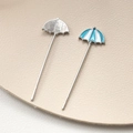 Detail view of blue and white enamel umbrella charm for DIY jewelry with silver finish - Blue