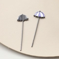 Macro detail of gold-plated umbrella charms with purple and white enamel finish - Purple