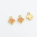 Detailed close-up of maple leaf pendants in gold plating with orange enamel finish - 5# Maple Leaf