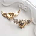 Close-up of golden winged heart earrings with clear cubic zirconia on ceramic tray - Gold (4#)