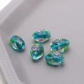 Macro shot of 5 teal vintage floral glass beads with gold foil for DIY jewelry making - Lake Blue