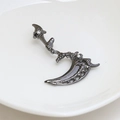 Detail of gothic scythe earring in gun black finish with sparkling white zircon accents - Gunmetal