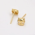 Detail of gold-plated cat-shaped skull studs with hollow eyes on white background - Gold Mask Style