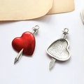 Detail of red heart pendant with silver sword, showing polished front and textured back - Heart Pierced By Sword Silver (D1907-9)