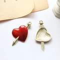 Detail of red enamel heart and arrow pendant showing polished front and gold textured back - Heart Pierced By Sword Gold (D1907-10)