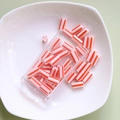 Close-up of orange and white striped tube beads in a clear storage box for DIY jewelry - 1 Box (Approx. 10g) / 2# Red White Stripes