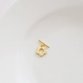 Detail of 14k gold plated flower toggle clasp for DIY jewelry making on a white tray - Polished Plum Blossom / 18K